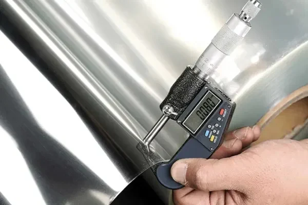 Checking the thickness of a plastic sheet roll